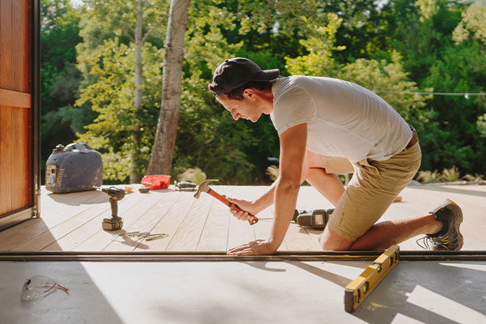 Man using tools to build a deck